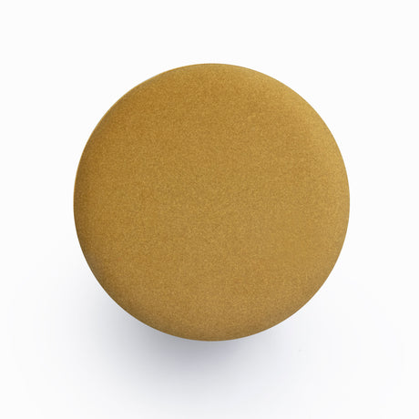 Dex round upholstered ottoman three-quarter studio view