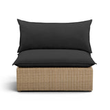 Cali outdoor armless chair in natural wicker finish paired with cream performance fabric cushions