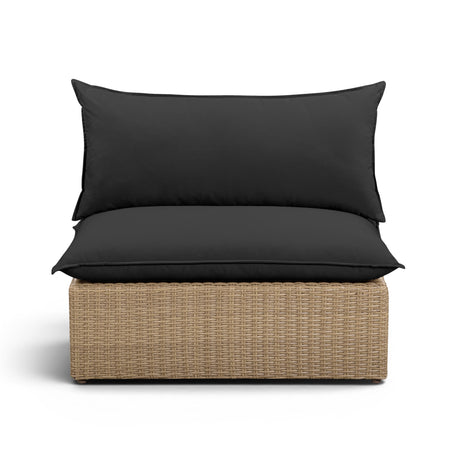 Cali outdoor armless chair in natural wicker finish paired with cream performance fabric cushions