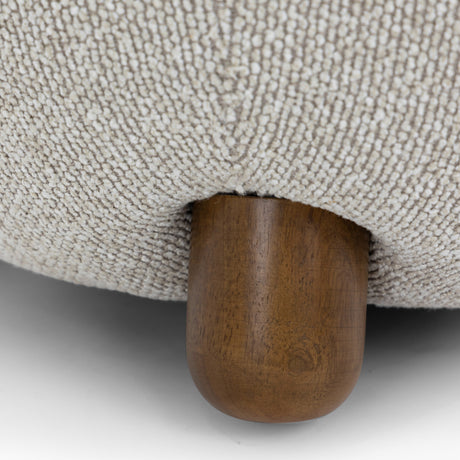 Macro shot of the spherical solid wood ball foot supporting the Pucker Accent Chair