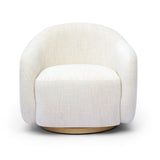 FOAK Salma swivel chair styled beside an end table in an open-concept living area