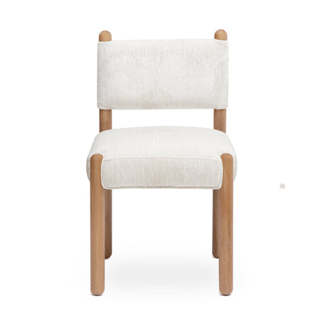Bruno performance chenille dining chair placed beside a contemporary wooden dining table