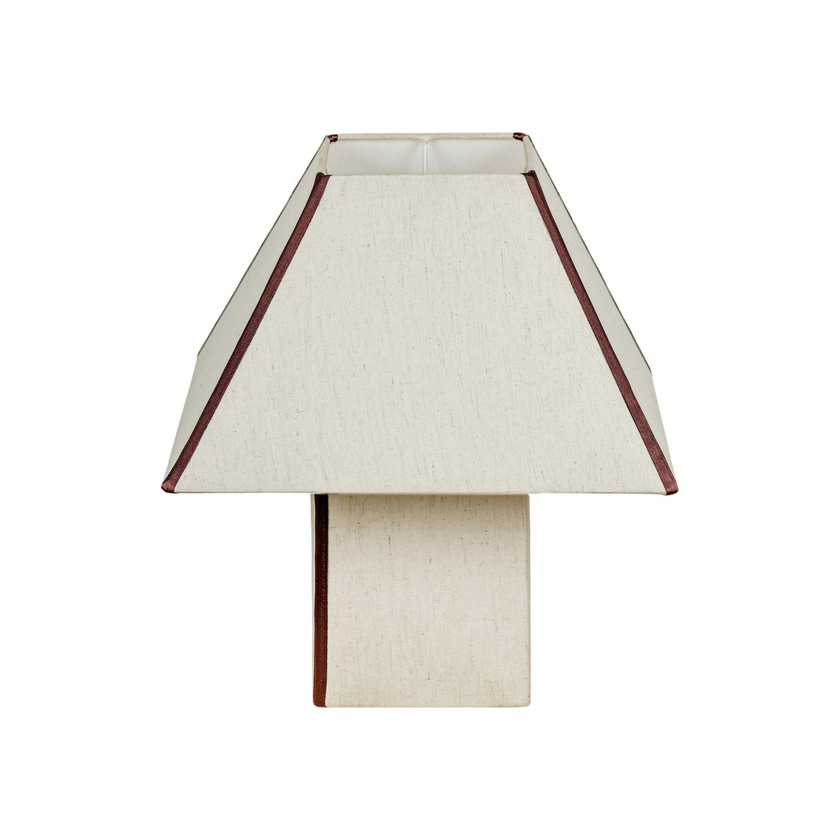 Front angle view of FOAK Josephine geometric pyramid table lamp illuminating living room
