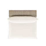 Cali wicker armless chair styled on an outdoor patio terrace with garden background