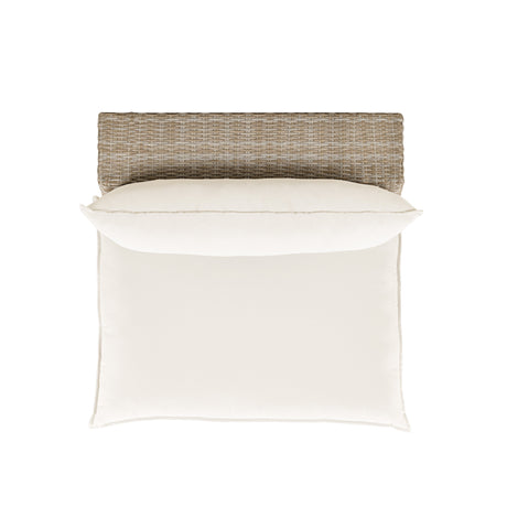 Cali wicker armless chair styled on an outdoor patio terrace with garden background