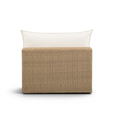 Three-quarter angle of the brown wicker Cali outdoor modular chair with cream cushioning