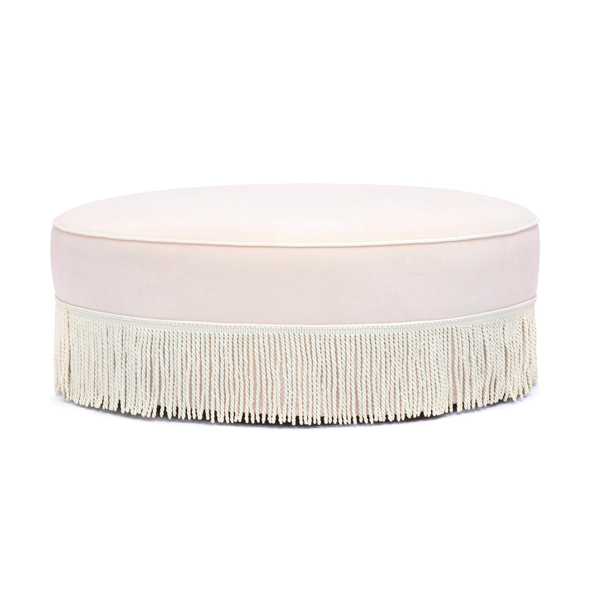 Tassy Tasseled Round Ottoman in pink velvet angled perspective highlighting contrast piping