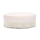 Tassy Tasseled Round Ottoman in pink velvet angled perspective highlighting contrast piping