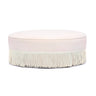 Tassy Tasseled Round Ottoman in pink velvet angled perspective highlighting contrast piping