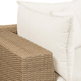 Sunlit patio scene featuring Cali 80-inch wicker loveseat with neutral fabric cushions