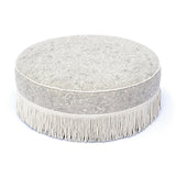 Side profile of Tassy Round Ottoman emphasizing round structure and tailored seams