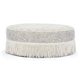 Neutral floral Tassy Round Ottoman arranged as dressing vanity stool seating