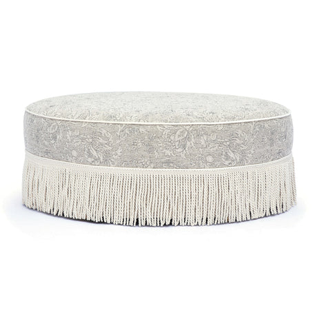 Neutral floral Tassy Round Ottoman arranged as dressing vanity stool seating