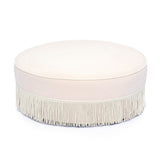 Tassy Tasseled Round Ottoman in pink velvet front view showing tassel fringe trim