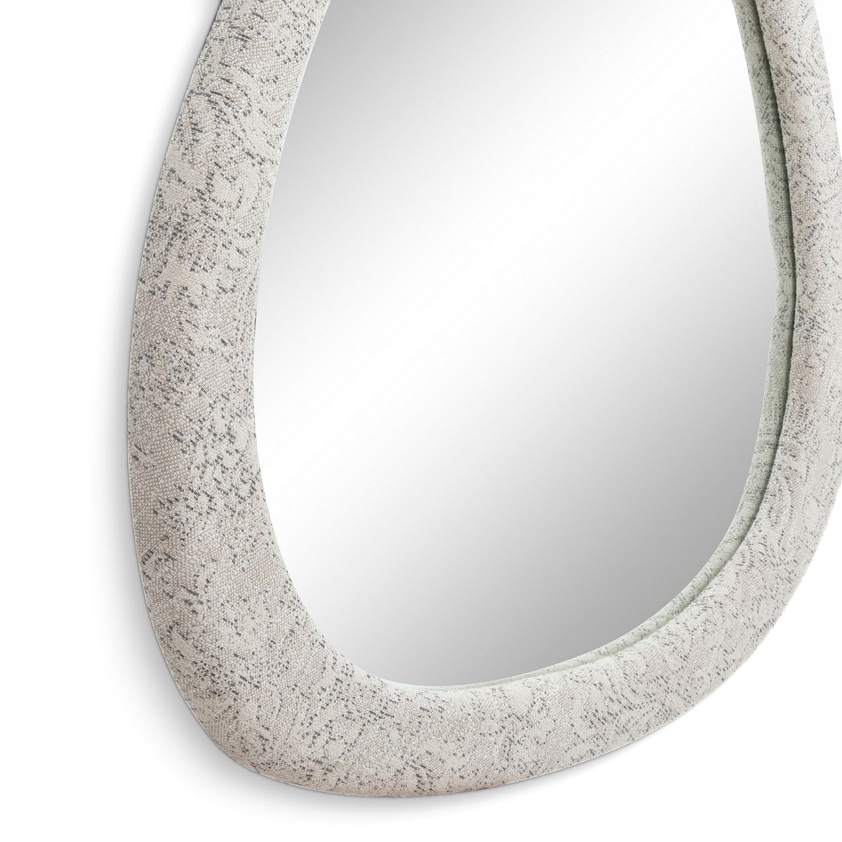 Klaryss asymmetric organic mirror mounted over a console table in a contemporary entryway