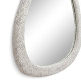 Klaryss asymmetric organic mirror mounted over a console table in a contemporary entryway