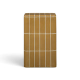 Ochre concrete side table close-up displaying dimensional tile pattern