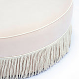 Top view of Tassy Round Ottoman showcasing circular silhouette and smooth velvet finish