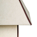 Close-up of contrast welt trim and woven fabric shade on pyramid accent table lamp