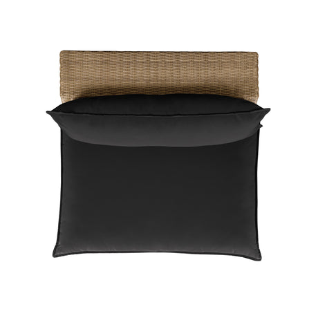 Three-quarter view of the natural wicker Cali patio chair featuring cream cushions