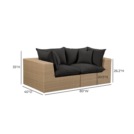 Full setting perspective of Cali outdoor wicker loveseat in a contemporary backyard patio