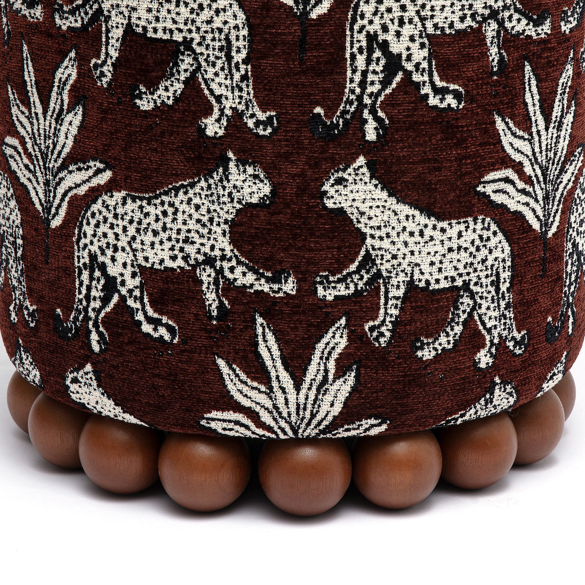 Dex accent footstool positioned beside an upholstered armchair