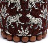 Dex accent footstool positioned beside an upholstered armchair