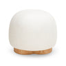 Oopa Swivel Ottoman situated next to a modern standing floor lamp