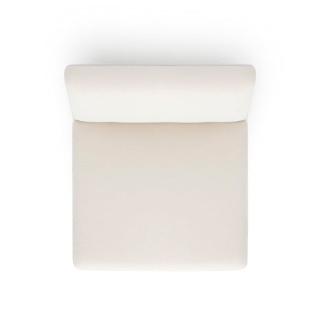 Pensel Dining Chair in Off-White fabric placed under natural architectural interior lighting