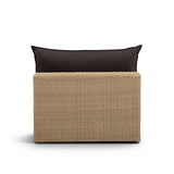 Side view of the natural wicker frame and cream outdoor seat cushion on the Cali chair