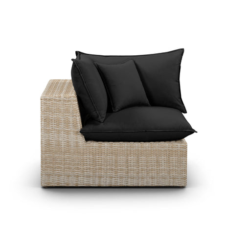 Angled view of black cushion upholstery on natural wicker Cali outdoor corner chair
