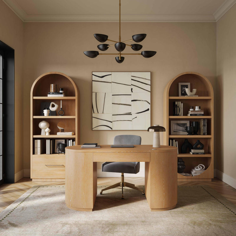 Modern home office with wooden desk, bookshelves, and abstract art on the wall.