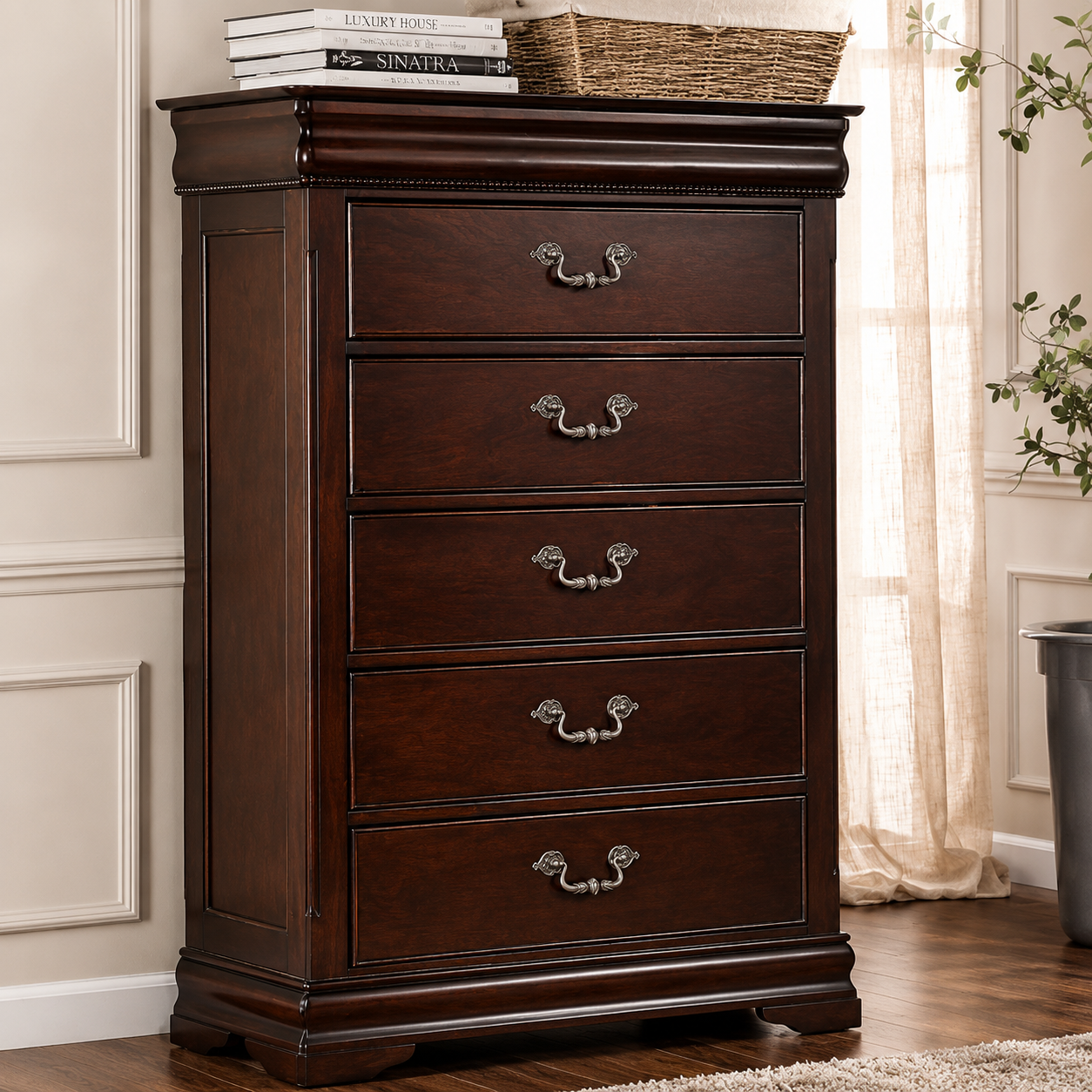 A dark brown wooden five-drawer chest with ornate silver metal handles, styled in a home setting with books and a wicker basket on top.